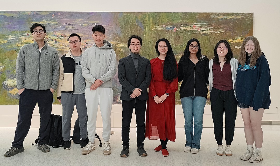 AI for Humanities students standing in front of a watercolor painting